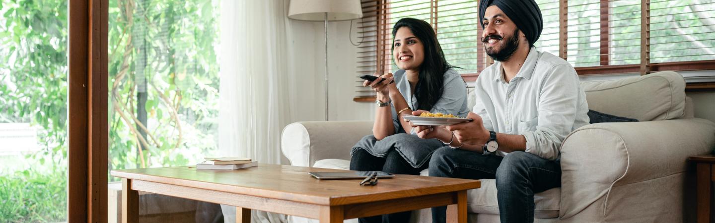 A Sikh couple sitting on a sofa 